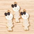Three cute skeleton pendants with black bows on a natural wooden background for DIY jewelry - 10 Pieces Pack / Gold White Black