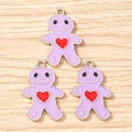 Macro detail of three purple gingerbread man alloy charms with heart and silver edges - 10 Pieces Pack / Purple
