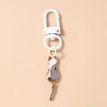 Close-up of cute cartoon cat keychain with swinging tail detail and white metal clip - Grey White Cat