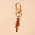 Detail of cute orange tabby cat keychain with golden lobster clasp and movable tail - Brown and Black Cat