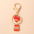 Detail eines Feuerwehrmann-Schlüsselanhängers mit Emaille-Handschuh und Schutzweste - Rote Sicherheitsweste und Handschuhe