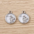 Detailed macro view of silver angel wing pendants with mother of pearl inlay on wood - Silver White Angel