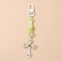 Detail of silver hollow gothic cross with green rhinestone and striped beads keychain - Beaded Silver Cross
