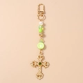 Detail of beaded keychain with green gems, striped beads and golden ornate cross - Round Badge Gold Cross