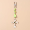 Detail of silver cross pendant keychain with green beads and striped cube charm - Silver Cross