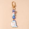 Detail of beaded dinosaur keychain with gold clasp and blue acrylic charms - Reading Dinosaur