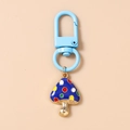 Detail of blue mushroom keychain with colorful dots and golden alloy finish - Blue Mushroom