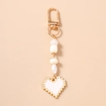 Detail of pixel heart keychain featuring white beads, gold hardware, and a lobster clasp - White
