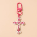 Detail of pink rhinestone-encrusted cross keychain with matching horseshoe clasp hook - Pink & Silver