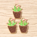 Detail of three enamel cactus charms with green leaves and pink buds for DIY jewelry - Brown