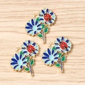Detail of blue daisy flower charms with red ladybug detail on golden alloy base - 10 Pieces Pack / Blue Flower