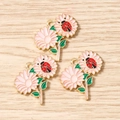Detailed macro of pink daisy flower charms with red ladybug for DIY jewelry making - 10 Pieces Pack / Pink Flower