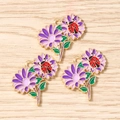Close-up of three purple daisy pendants with red ladybugs and gold metal detailing - 10 Pieces Pack / Purple Flower