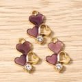 Dettagli di ciondoli a cuore in smalto viola con strass e placcatura in oro per gioielli DIY - Rosa antico