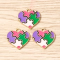 Close-up of heart puzzle pendants with colorful enamel and gold-plated frames for DIY jewelry - 10 Pieces Pack / Purple Green Heart Puzzle