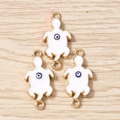 Detailed view of three gold turtle evil eye charms for jewelry making on wood background - 10 Pieces Pack / White