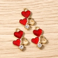 Detailed macro view of red enamel heart charms with gold frames and zircon stones - 10 Pieces Pack / Red