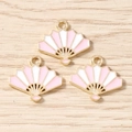 Flat lay of pink fan-shaped alloy pendants with gold plating for jewelry making - 10 Pieces Pack / Pink White