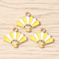 Detailed macro view of three golden fan-shaped enamel charms for DIY jewelry making - 10 Pieces Pack / Amber White