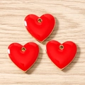 Detailed view of three red enamel heart charms with gold finish for DIY jewelry crafting - Red