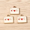 Detail of envelope alloy charms with white enamel and golden arrow-pierced red heart - 10 Pieces Pack / White