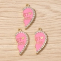 Close-up of pink enamel heart pendants with rhinestones for best friends jewelry DIY - Rose Red