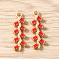 Détail macro de pendentifs pétards en émail rouge avec anneaux dorés pour bijoux DIY - Lot de 10 / Pétard Doré