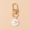Détail d'un porte-clés de basket-ball blanc avec un fermoir mousqueton doré - Blanc Rouge