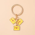 Close-up of golden alloy keychain with yellow enamel envelope charms and red heart arrow detail - Yellow