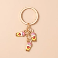 Detailed close-up of heart-pattern milk tea cup pendants on a golden keychain ring - Yellow Milk Tea