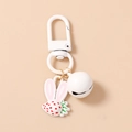 Close-up of strawberry rabbit keychain with white bell and pink ear charm detail - White