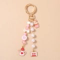 Detalle de llavero de cuentas con colgantes de cupcake rosa, casete y corazón dulce - Botella de Agua & Cupcake