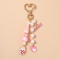 Detail view of pink beaded keychain with 1314 pendant and heart-shaped spring clasp - Heart 1314