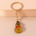Sparkly amber resin snowman keychain with gold metal ring and festive glitter finish - Snowman