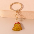 Golden keychain with yellow glitter bell pendant and red bow detail for Christmas decor - Christmas Bell