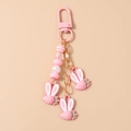 Detail of pink strawberry pendants with rabbit ears on golden chain keychain - Pink Strawberry Rabbit