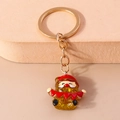 Cute Santa Claus keychain with gold finish and yellow glitter resin figurine accessory - Christmas Character