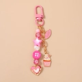 Detailed macro shot of a pink resin beaded keychain with heart and cupcake charms - Heart Lips Cake