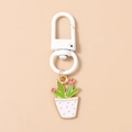 Detailed close-up of a cactus plant keychain with white D-ring and enamel metal pendant - White