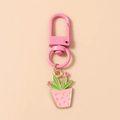 Detailed view of a cartoon cactus keychain with pink D-ring and zinc alloy pendant - Pink