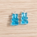 Close-up of two blue resin gummy bear charms with silver metal rings for DIY jewelry - 10 Pieces Pack / Lake Blue