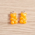 Macro detail of two orange resin gummy bear pendants with shimmering iridescent sequins - 10 Pieces Pack / Orange