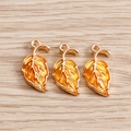 Detail of gradient orange enamel maple leaf charms with golden metallic edges and loops - Yellow