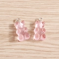 Macro shot of pink translucent resin gummy bear charms with silver hooks on wood background - 10 Pieces Pack / Pink