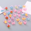 Set of 12 colorful acrylic animal and fruit rings for kids with various cute cartoon designs - Sequin Style