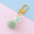 Cute mint green fluffy pompom keychain with a transparent iridescent star charm - Green