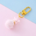 Pink plush ball keychain with a star-shaped charm and gold swivel clasp on pastel background - Light Pink
