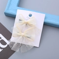 Set di due fermagli per capelli con fiocchi in rete color crema e glitter dorati - Beige