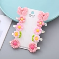 Set of 10 pink floral and bow resin hair clips for girls on display card - Pink Flower