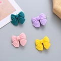 Set of four matte resin bow hair clips in green, purple, pink, and yellow colors - Random Bow